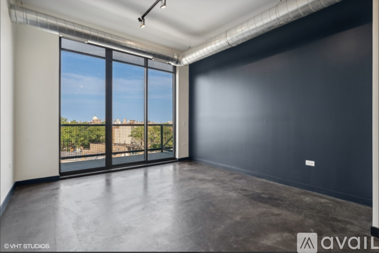 A spacious room with large windows overlooking a cityscape.