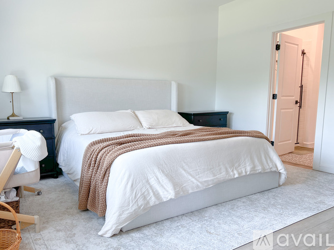 A bedroom with a large bed and a smaller bed in the corner.