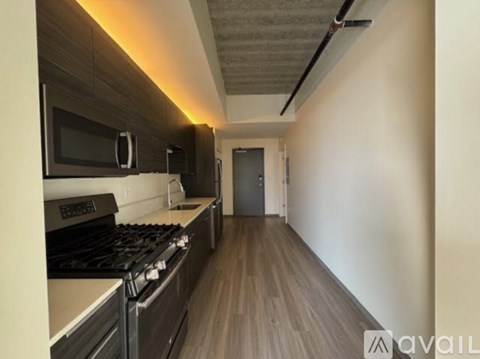 A kitchen with a stove top oven and microwave.