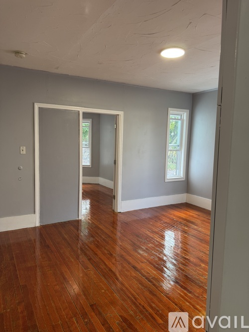 A room with wooden floors and a window.