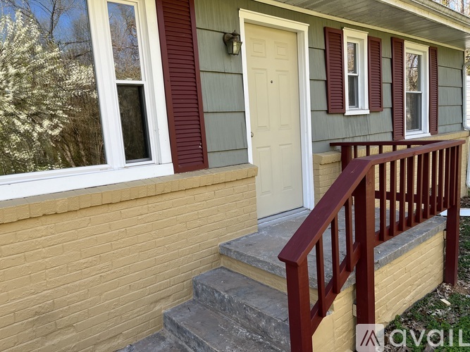 A house with a red door and a white window.