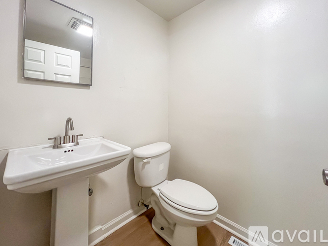 A white sink and toilet in a small bathroom.
