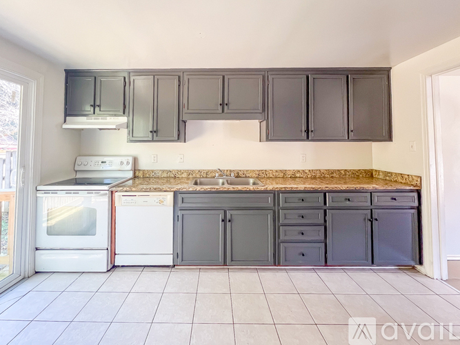 A kitchen with a white oven and a white stove top.
