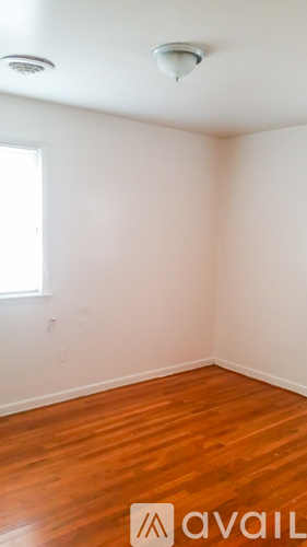A room with wooden floors and white walls.