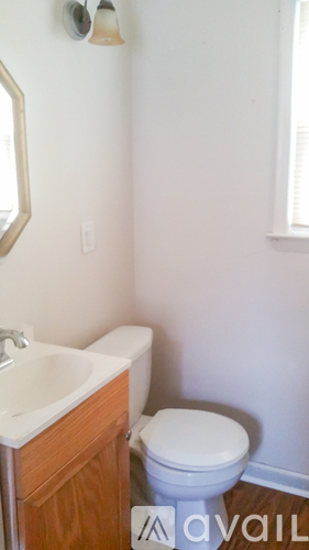 A white toilet sits next to a sink in a small bathroom.