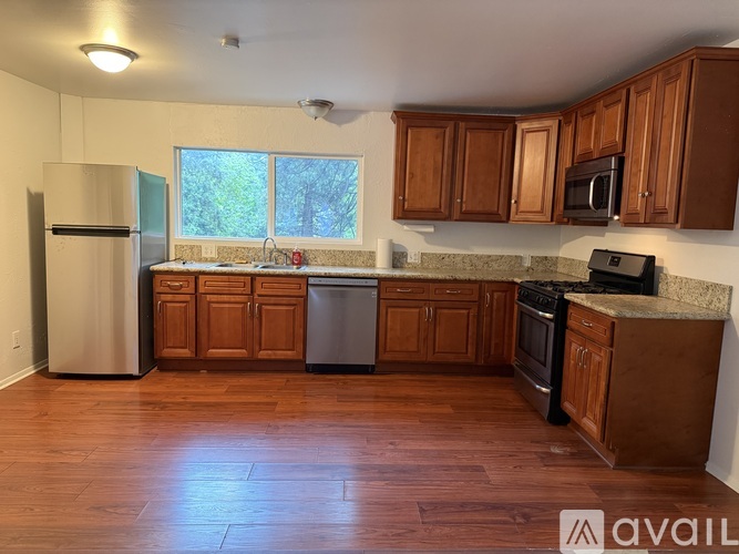 A kitchen with wooden cabinets and a refrigerator.