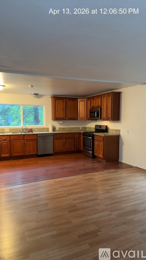 A kitchen with wooden cabinets and a stainless steel dishwasher.