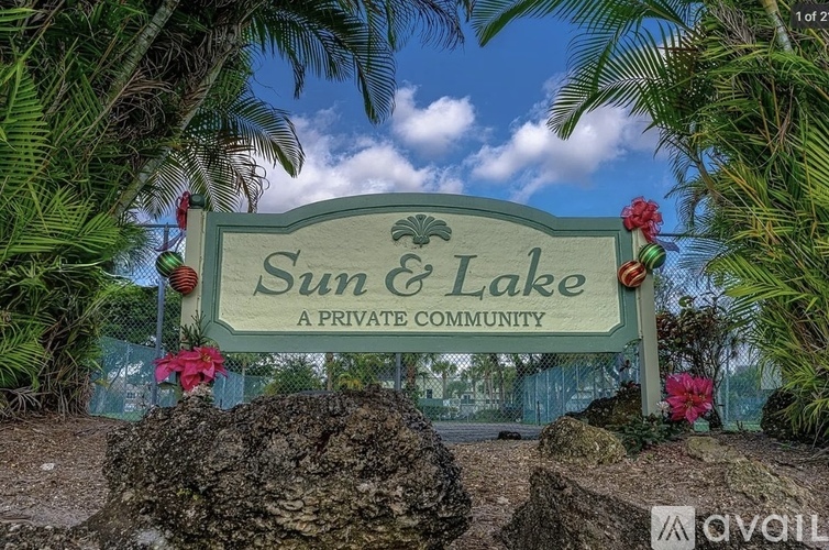 A sign that says Sun & Lake in front of some trees.