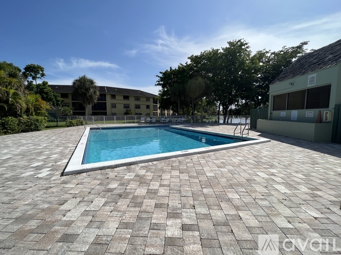 A small pool surrounded by a brick patio.