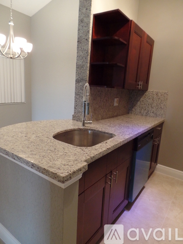 A kitchen with a sink and cabinets.