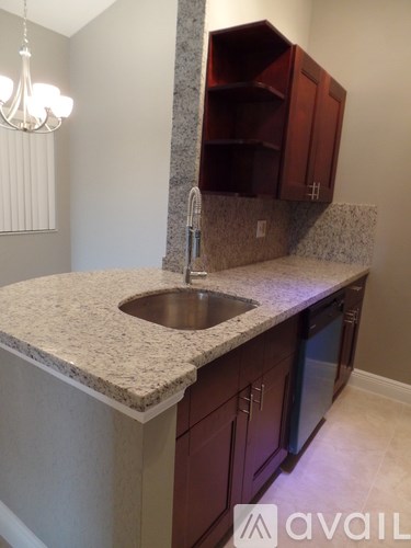 A kitchen with a sink and cabinets.