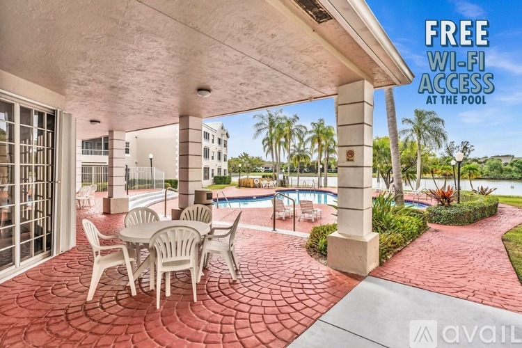 A patio area with chairs and a pool is advertised to have free Wi-Fi.