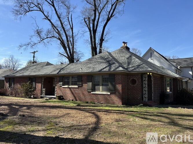 A house with a red brick exterior and a grey roof.