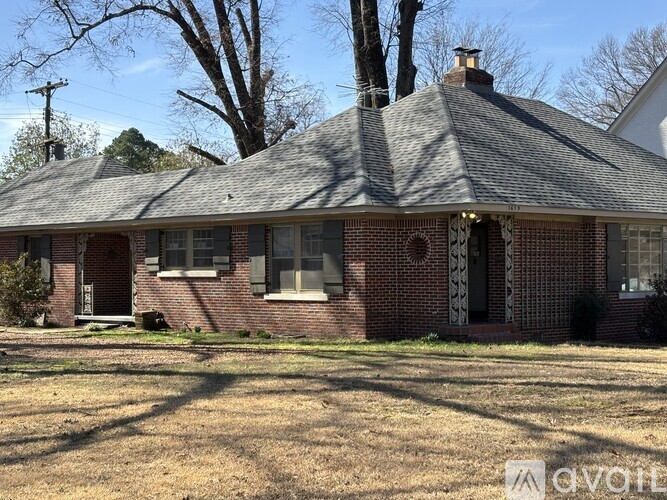 A house with a red brick exterior and a grey roof.