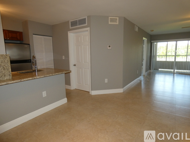 A spacious room with a counter and a door.