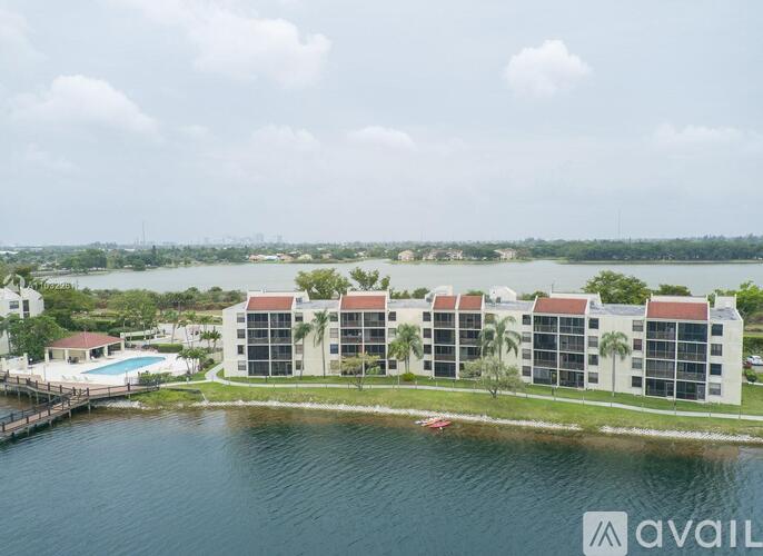 A row of modern buildings with a pool in front of them.