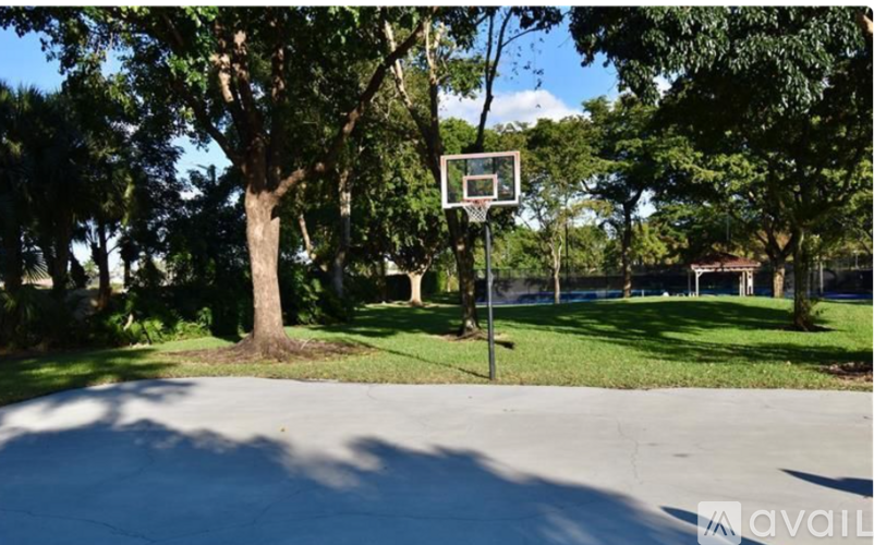 A basketball hoop is mounted on a pole in the middle of a basketball court.