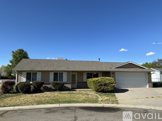 A house with a garage and a driveway in front.