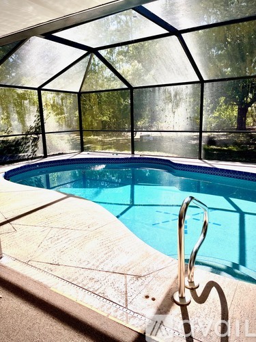 A pool with a diving board and a metal ladder.