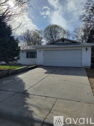 A house with a white garage door is for sale.