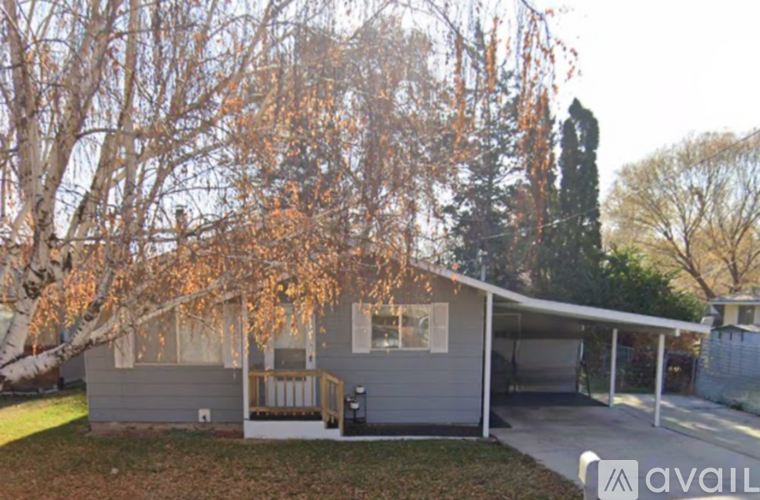A house with a grey exterior and a covered patio.