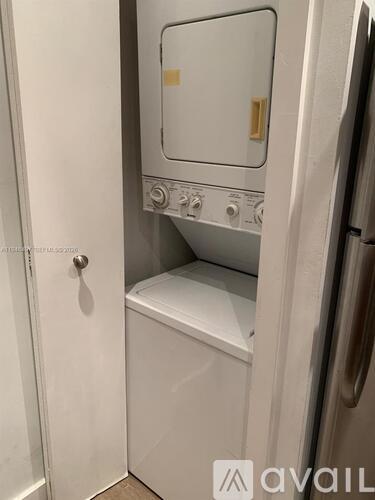 A white washing machine with a door open.