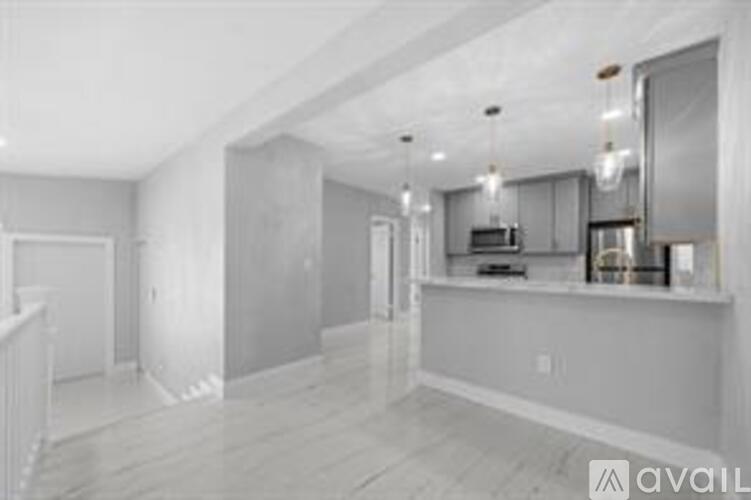 A spacious kitchen with a large island and a dining area.