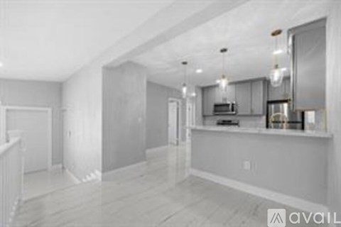 A spacious kitchen with a large island and a dining area.