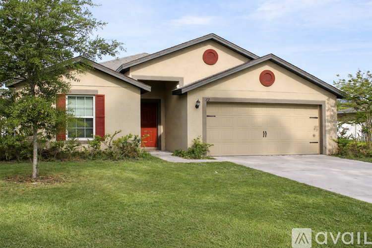 A house with a red door and a garage door.