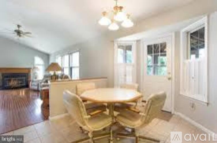 A dining room with a table and chairs is available for rent.