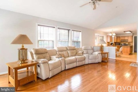 A living room with a white sofa and a wooden coffee table.