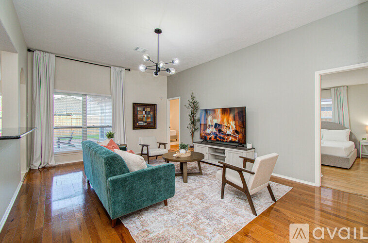 A living room with a green couch and a television.