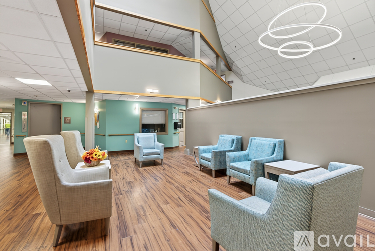 A room with a wooden floor and a white ceiling with a circular light fixture.