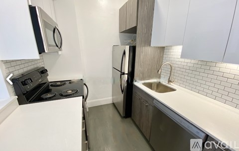 A small kitchen with a stove, refrigerator, and a white countertop.