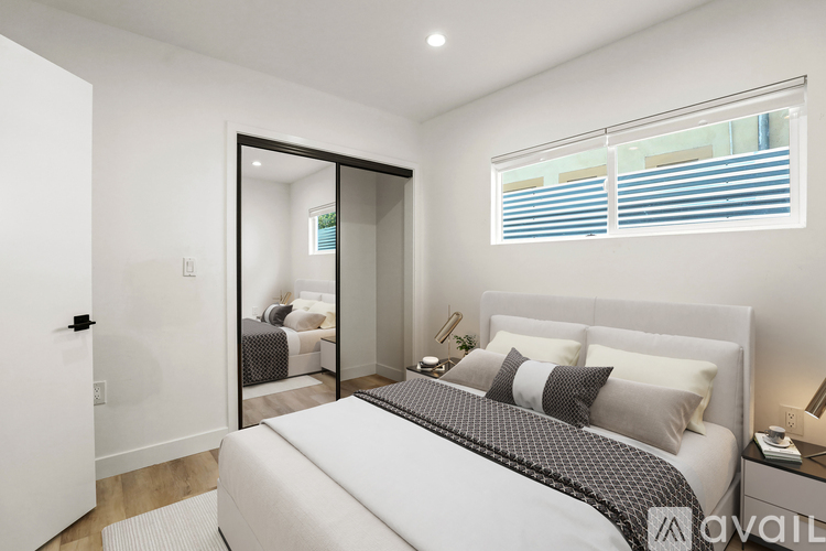 A bedroom with a large bed and a mirror on the wall.