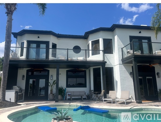 A modern house with a pool in front.