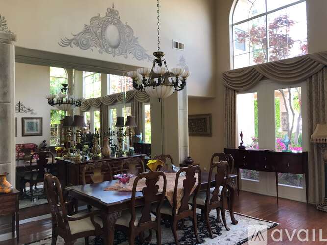 A dining room with a table set for a meal.