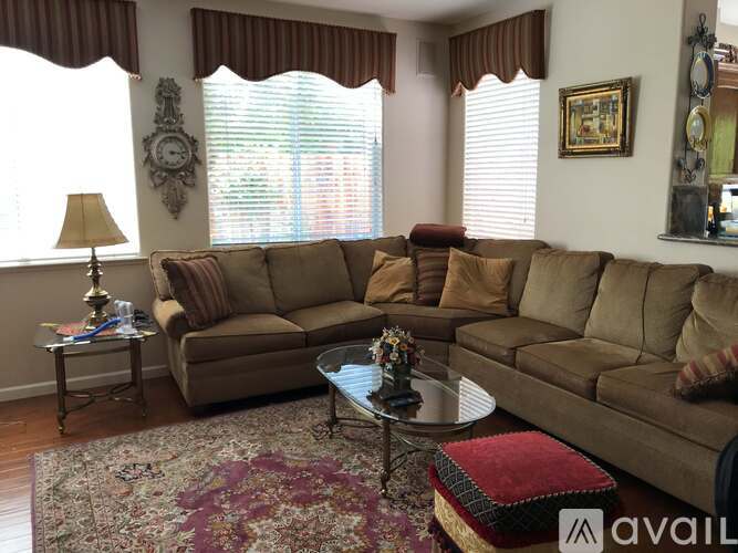 A living room with a large sectional sofa and a coffee table in front of it.