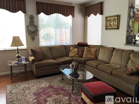 A living room with a large sectional sofa and a coffee table in front of it.