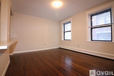 A room with wooden floors and a window.