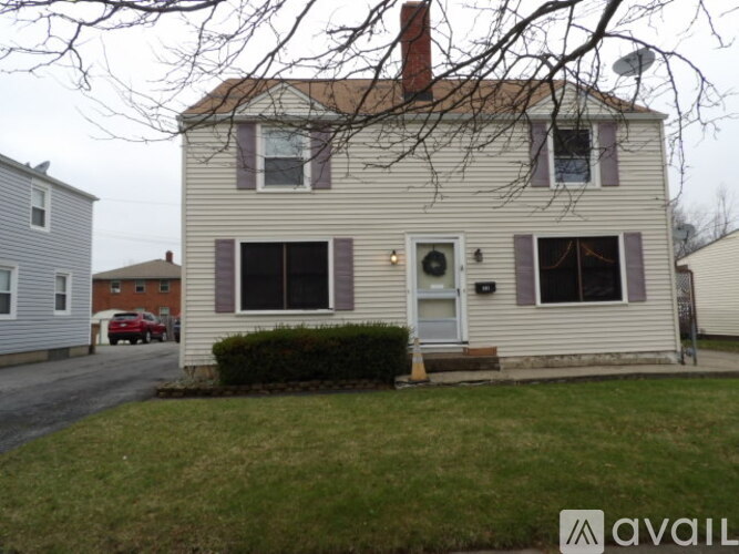 A house with a white front door and a small porch.