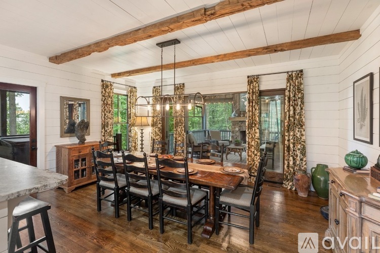 A dining room with a wooden table and chairs.