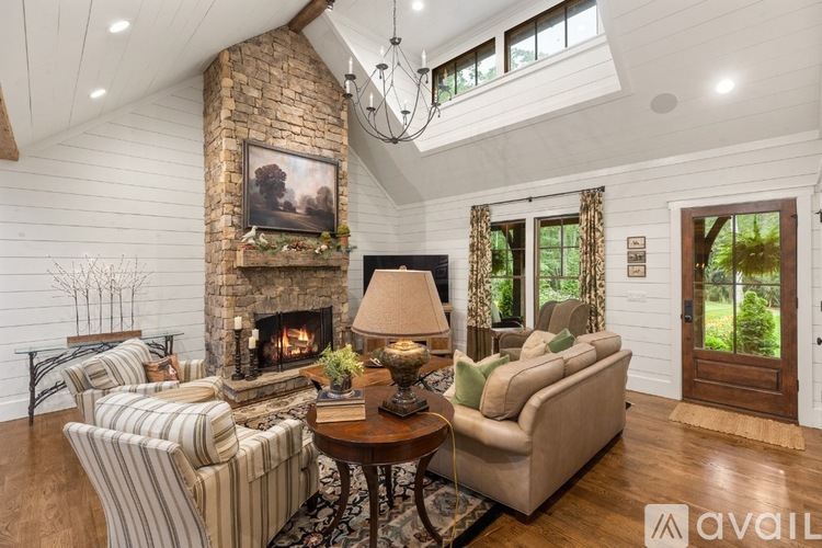 A living room with a fireplace and a painting on the wall.
