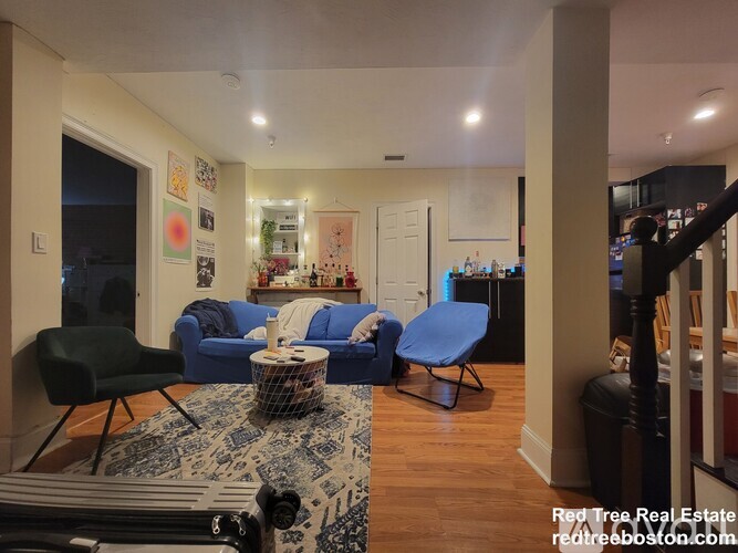 A living room with a blue chair and a blue couch.