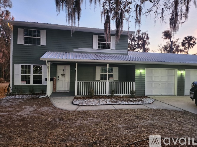 A house with a white door and a white fence.