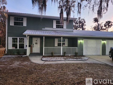 A house with a white door and a white fence.