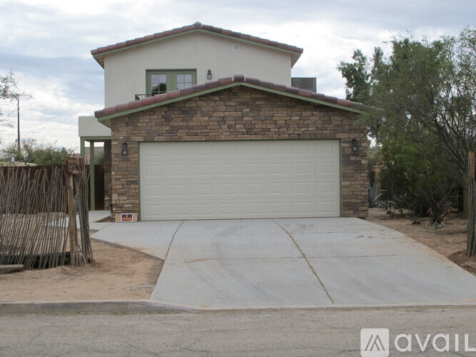 A house with a garage door and a driveway.