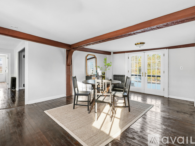 A dining room with a table set for four.