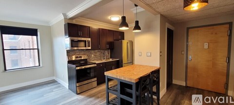 A kitchen with a wooden table and a window.