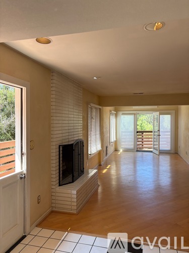 A living room with a fireplace and a television.